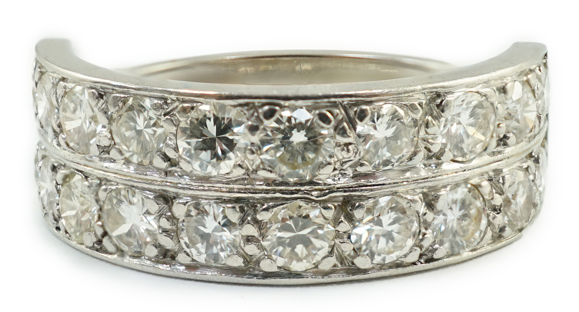 A white gold and two row twenty stone diamond set half eternity ring